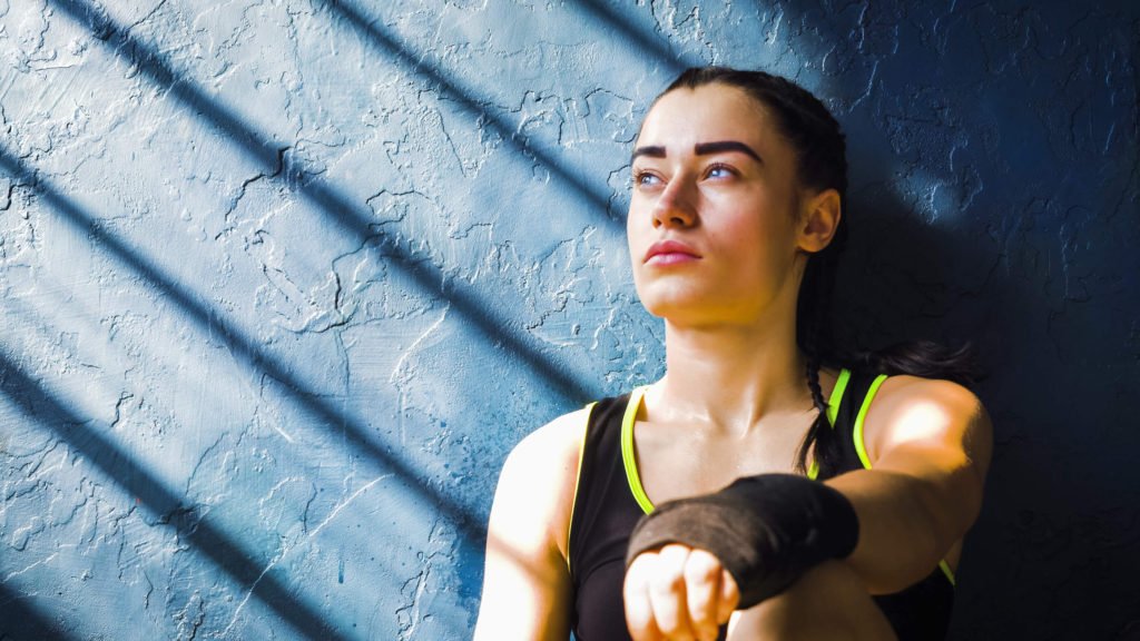 woman thinking after a martial arts workout.