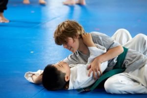 Child practicing grappling and jiu-jitsu