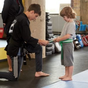 Child getting a belt promotion in a kids karate class